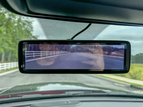 Front interior view with mirror display, dashboard, and windshield.